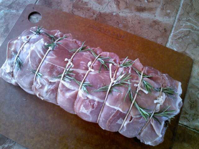 Pork loin stuffed, tied and ready for searing.